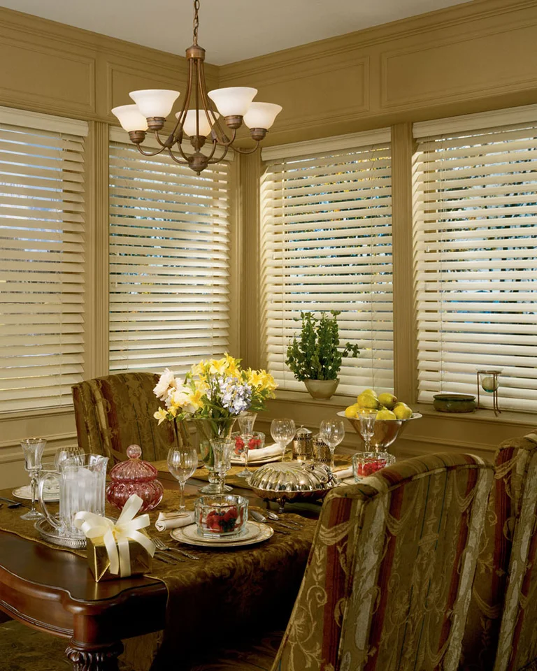 Faux wood blinds in a sunny dining room
